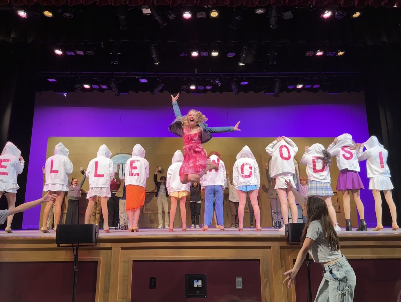 Emme in a theater jump pose